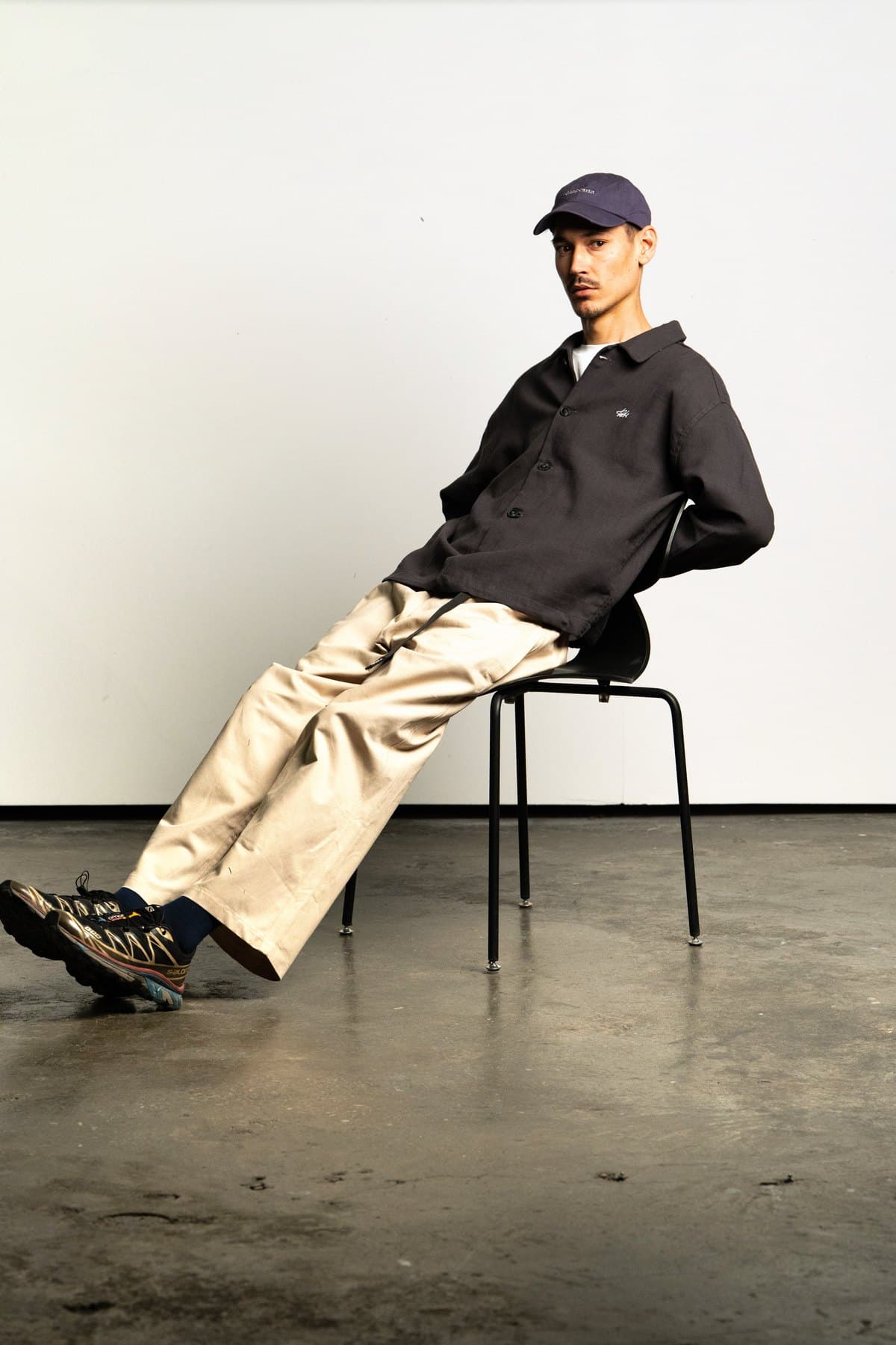 Black Coach Jacket — On model, seated