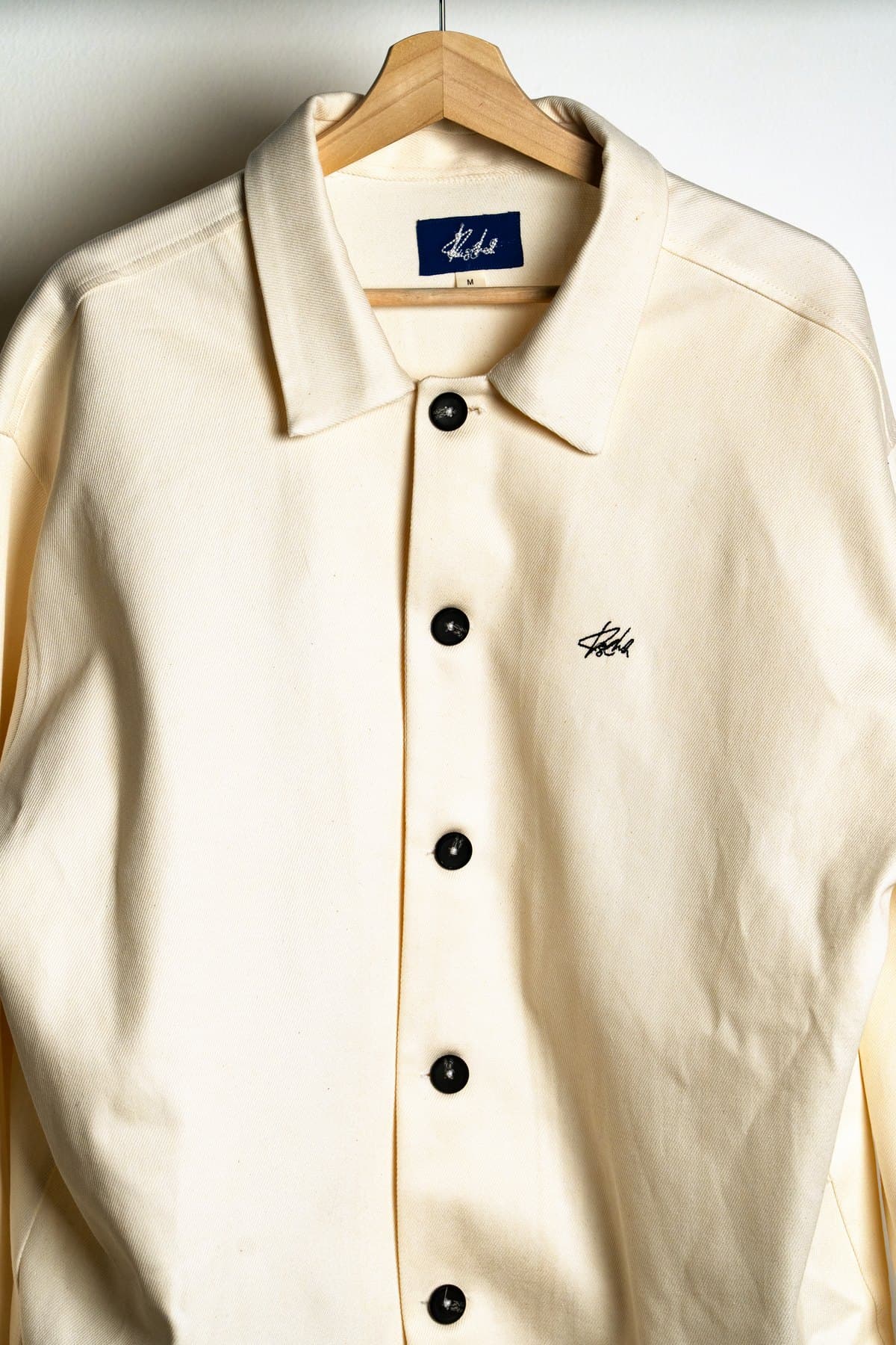 Ecru Coach Jacket — Collar and label